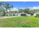 Beautiful home with a manicured lawn and a driveway that leads to the garage at 25106 Quaker Ridge Ave, Sorrento, FL 32776