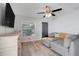 Comfortable living room with a large sectional, ceiling fan and natural light at 25106 Quaker Ridge Ave, Sorrento, FL 32776