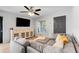 Relaxing living room features a large sectional sofa, a media center, and plenty of light at 25106 Quaker Ridge Ave, Sorrento, FL 32776