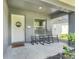 Charming front porch with rocking chairs, welcome mat, and a view of the neighborhood at 25106 Quaker Ridge Ave, Sorrento, FL 32776