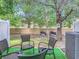 Backyard patio area with four chairs on artificial turf and large tree at 2662 Mayaguana St, Kissimmee, FL 34747