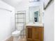 Compact half bathroom features a vanity and toilet with shelving at 2662 Mayaguana St, Kissimmee, FL 34747