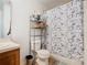 Bathroom featuring a vanity, toilet, and tub/shower with butterfly curtain at 2662 Mayaguana St, Kissimmee, FL 34747