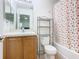 Bathroom with vanity, shelving unit, toilet, and bathtub/shower with flower shower curtain at 2662 Mayaguana St, Kissimmee, FL 34747
