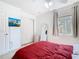 Cozy bedroom featuring a mounted TV, closet, and a bright window view at 2662 Mayaguana St, Kissimmee, FL 34747