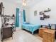 Bedroom with light blue decor, ceiling fan, and tile flooring at 2662 Mayaguana St, Kissimmee, FL 34747