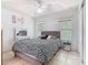 Bedroom with ceiling fan, two windows, closet and bed with black and white patterned bedding at 2662 Mayaguana St, Kissimmee, FL 34747