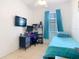 Bedroom with a TV, desk and blue bedspread at 2662 Mayaguana St, Kissimmee, FL 34747