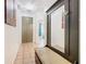 Inviting hallway with tiled floors and decorative mirror at 2662 Mayaguana St, Kissimmee, FL 34747