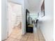 Hallway view showcasing tile flooring, seating area and half bathroom at 2662 Mayaguana St, Kissimmee, FL 34747