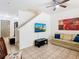 Cozy living room with modern television, comfortable seating, and staircase access at 2662 Mayaguana St, Kissimmee, FL 34747