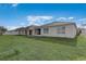 Well maintained backyard with lush green grass and white fences surrounding the perimeter at 269 St Georges Cir, Eagle Lake, FL 33839