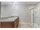 Bathroom featuring double sinks with granite countertops and a glass-enclosed shower at 269 St Georges Cir, Eagle Lake, FL 33839