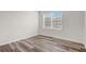 This bedroom features a window with blinds and wood-style flooring at 269 St Georges Cir, Eagle Lake, FL 33839