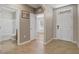 Welcoming hallway displaying entrances to a bathroom, bedroom and the front door at 269 St Georges Cir, Eagle Lake, FL 33839