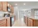 Open kitchen featuring tile backsplash, stainless steel sink, wooden cabinets, and black appliances at 269 St Georges Cir, Eagle Lake, FL 33839