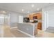 Bright kitchen featuring an island with sink, tile backsplash, and wooden cabinets at 269 St Georges Cir, Eagle Lake, FL 33839
