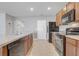 Modern kitchen with an island, tile backsplash, stainless steel sink, and black appliances at 269 St Georges Cir, Eagle Lake, FL 33839