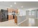 Bright kitchen featuring an island with sink, tile flooring, and black appliances at 269 St Georges Cir, Eagle Lake, FL 33839
