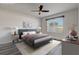 Comfortable main bedroom with modern decor, a ceiling fan, and a window for natural light and exterior views at 269 St Georges Cir, Eagle Lake, FL 33839