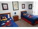 Charming bedroom with two twin beds, themed decor, and framed art, creating a welcoming and fun space at 2785 Almaton Loop # 204, Kissimmee, FL 34747