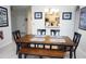 Inviting dining area with a wooden table, bench seating, and view of the kitchen bar and cabinets at 2785 Almaton Loop # 204, Kissimmee, FL 34747