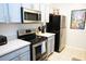 Efficient kitchen featuring stainless steel appliances, light-colored cabinets, and modern countertops at 2785 Almaton Loop # 204, Kissimmee, FL 34747