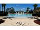 Large community pool with palm trees and water park attractions in the background at 2785 Almaton Loop # 204, Kissimmee, FL 34747