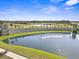 Scenic aerial view of Venetian Bay with a large lake, fountain, and lush landscaping at 280 Caryota Ct, New Smyrna Beach, FL 32168