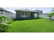 Grassy backyard with white fence and covered patio, perfect for outdoor enjoyment and entertaining at 280 Caryota Ct, New Smyrna Beach, FL 32168