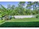 Spacious backyard with white vinyl fence and mature trees offering privacy at 280 Caryota Ct, New Smyrna Beach, FL 32168