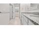 Contemporary bathroom with dual sinks, granite counters, and stylish fixtures, offers functional elegance at 280 Caryota Ct, New Smyrna Beach, FL 32168
