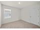 Bright bedroom showcasing a window for natural light and plush carpeting throughout at 280 Caryota Ct, New Smyrna Beach, FL 32168