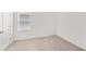 Clean, carpeted bedroom features a window with blinds and a neutral color palette at 280 Caryota Ct, New Smyrna Beach, FL 32168