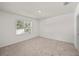 Neutral bedroom featuring carpeted flooring and a window offering natural light at 280 Caryota Ct, New Smyrna Beach, FL 32168
