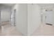 Open hallway with tile flooring leading to the front door and other rooms at 280 Caryota Ct, New Smyrna Beach, FL 32168