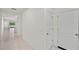 Bright hallway with tile floors and access to various rooms, showcasing the home's layout at 280 Caryota Ct, New Smyrna Beach, FL 32168
