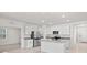Modern kitchen with white cabinets, granite countertops, stainless steel appliances, and center island at 280 Caryota Ct, New Smyrna Beach, FL 32168