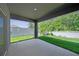 Covered patio overlooking the backyard with white vinyl fence and green lawn at 280 Caryota Ct, New Smyrna Beach, FL 32168