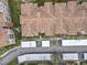 Aerial view of condo community featuring covered parking, landscaping, and tiled roofs at 3000 Laurel Park Ln # 202, Kissimmee, FL 34741