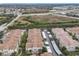 Aerial view of condos with covered parking and beautiful, mature landscaping near highway at 3000 Laurel Park Ln # 202, Kissimmee, FL 34741