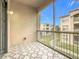 Screened balcony with patterned tile flooring, offering community views at 3000 Laurel Park Ln # 202, Kissimmee, FL 34741