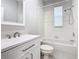 Bright bathroom featuring a white vanity, framed mirror, and a clean, tiled shower-tub combination at 3000 Laurel Park Ln # 202, Kissimmee, FL 34741