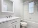 This bathroom features a white vanity and a shower-tub combo with tile surround at 3000 Laurel Park Ln # 202, Kissimmee, FL 34741