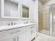 Elegant bathroom showcasing double vanity and glass enclosed shower at 3000 Laurel Park Ln # 202, Kissimmee, FL 34741