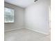 Well-lit bedroom with neutral walls, tile flooring and a window offering natural light at 3000 Laurel Park Ln # 202, Kissimmee, FL 34741