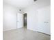 Bedroom featuring tile flooring, multiple closets, and doorway access to other rooms at 3000 Laurel Park Ln # 202, Kissimmee, FL 34741