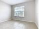 Bright, airy bedroom with tile flooring and large window providing ample natural light and outdoor views at 3000 Laurel Park Ln # 202, Kissimmee, FL 34741