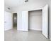 Bedroom showcasing tile flooring, two closets, and doorway access to a room at 3000 Laurel Park Ln # 202, Kissimmee, FL 34741
