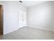 Bedroom with neutral wall and tile flooring showcasing a closet and doorway at 3000 Laurel Park Ln # 202, Kissimmee, FL 34741